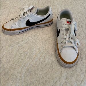 Nike White Low-Top Sneakers with Black Swoosh and Brown Accent